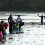 A group of illegal immigrants crosses the Rio Grande from Acuna, Mexico, to Del Rio, Texas