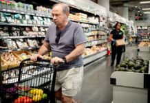 People shop at a grocery store in New York City