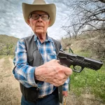 Cattle rancher Jim Chilton displays the 40-caliber handgun he carries when he goes out on his 50,000-acre ranch in Arivaca, Ariz., on March 22, 2024.
