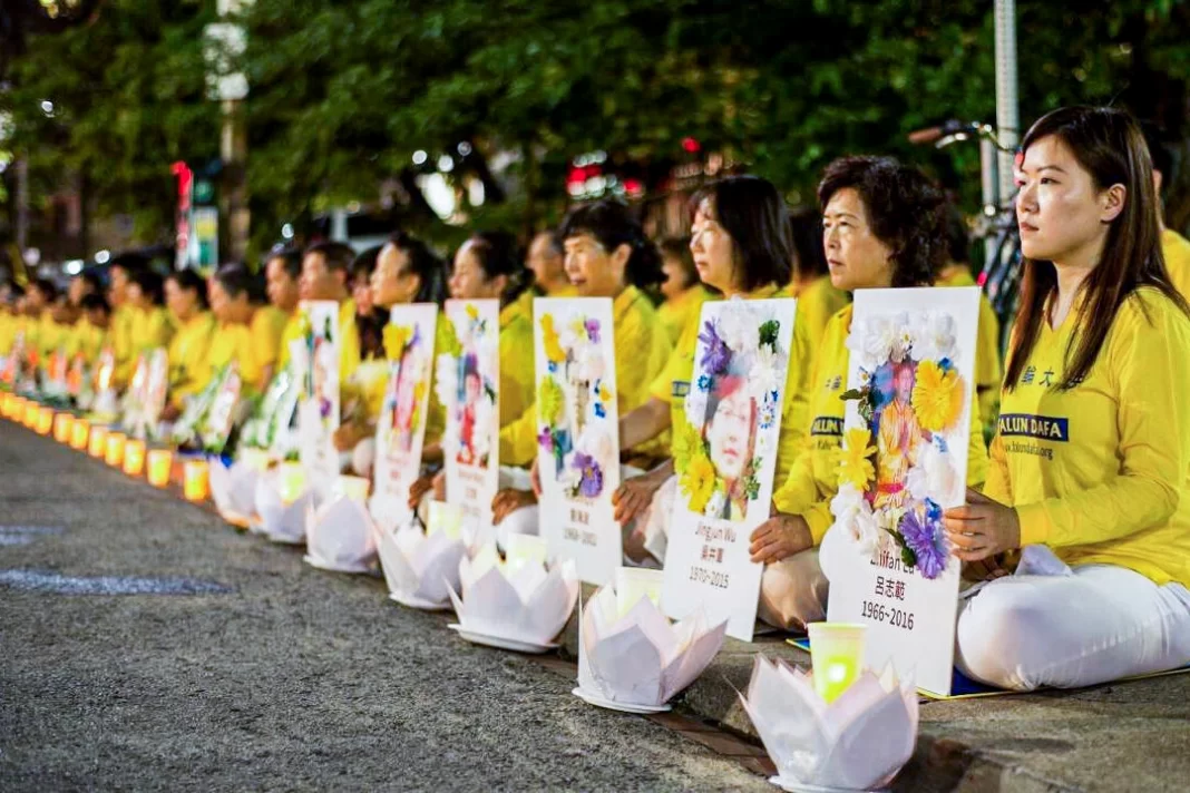 Falun Gong practitioners participate in a candlelight vigil