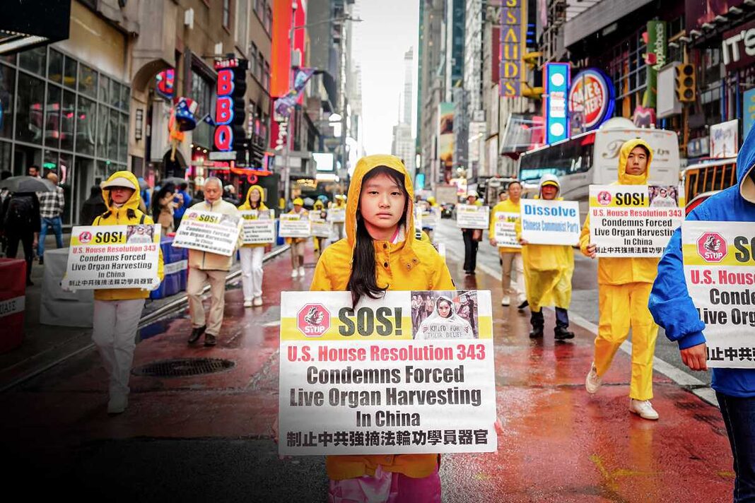 Falun Gong practitioners take part in a parade to celebrate World Falun Dafa Day