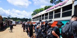 Chinese migrants at camp Canaán Membrillo in Panama load onto a bus in July 2024 for the next leg of their journey to cross the U.S. southern border illegally.