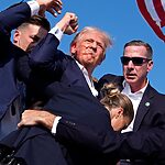 Bloodied Trump fist pumps after shots fired at rally