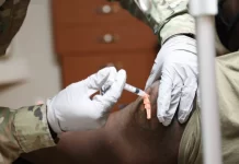 A member of the U.S. Navy receives a COVID-19 vaccine