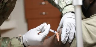 A member of the U.S. Navy receives a COVID-19 vaccine