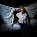 An elderly woman sits on her bed in Holguin, Cuba, on April 27, 2012.