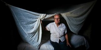 An elderly woman sits on her bed in Holguin, Cuba, on April 27, 2012.