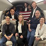 This image released by the White House shows Evan Gershkovich, left, Alsu Kurmasheva, right, and Paul Whelan, second from right, and others aboard a plane on Aug. 1, 2024, following their release from Russian captivity.