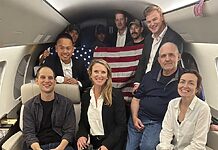 This image released by the White House shows Evan Gershkovich, left, Alsu Kurmasheva, right, and Paul Whelan, second from right, and others aboard a plane on Aug. 1, 2024, following their release from Russian captivity.