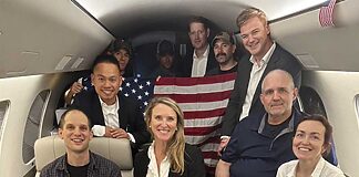 This image released by the White House shows Evan Gershkovich, left, Alsu Kurmasheva, right, and Paul Whelan, second from right, and others aboard a plane on Aug. 1, 2024, following their release from Russian captivity.