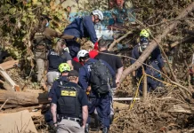 Rescue workers look for bodies following Hurricane Helene in Asheville, N.C., on Oct. 6, 2024.