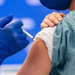 A person receives a COVID-19 vaccine