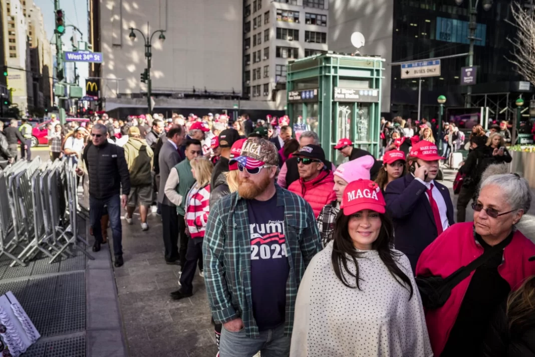 People wait in line to enter a rally with former president Donald J. Trump in Madison Square Garden in New York City on Oct. 27, 2024.