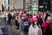 People wait in line to enter a rally with former president Donald J. Trump in Madison Square Garden in New York City on Oct. 27, 2024.