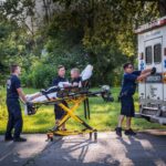 Paramedics attend to a man who is overdosing