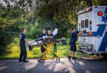 Paramedics attend to a man who is overdosing