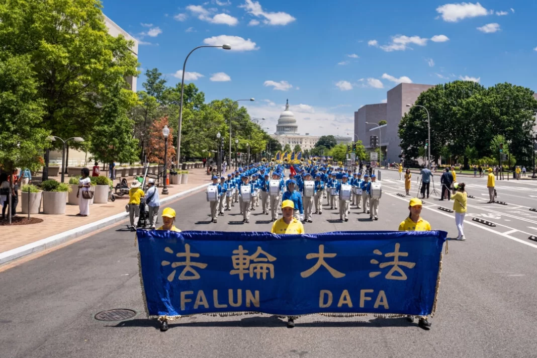 Falun Gong adherents march during parade calling for end of CCP’s 25 years of ongoing persecution