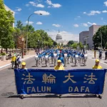 Falun Gong adherents march during parade calling for end of CCP’s 25 years of ongoing persecution