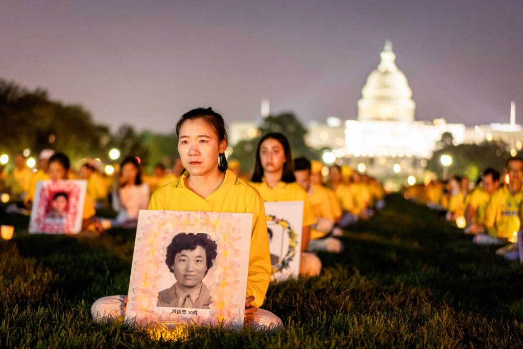 Falun Gong practitioners take part in a candlelight vigil