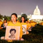 Falun Gong practitioners take part in a candlelight vigil