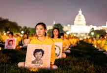 Falun Gong practitioners take part in a candlelight vigil