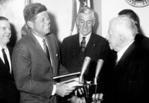 President John F. Kennedy presents the Congressional Gold Medal to Robert Frost.