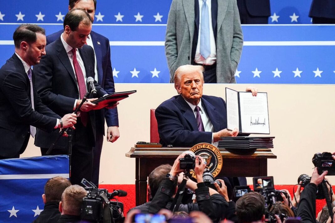 President Trump signs EOs at the Capital One Arena in Washington on Jan. 20, 2025.